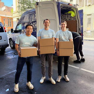 American Securities employees carrying boxes at West Side Campaign Against Hunger Event